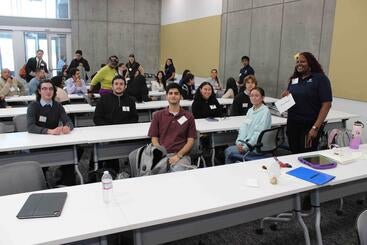 A group of CMSP scholars sitting at desks