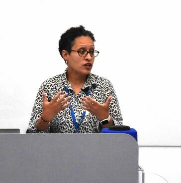 Dr. Fortuna lecturing behind a podium