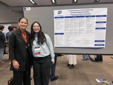 Stephanie Zheng standing in front of a research poster