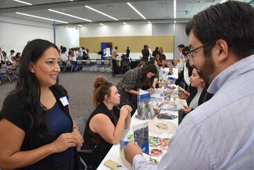 Nancy Hernandez speaks to a student while Amanda Trama speaks in the background