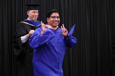 Jorge Delos Santos walking at MPH commencement 2026