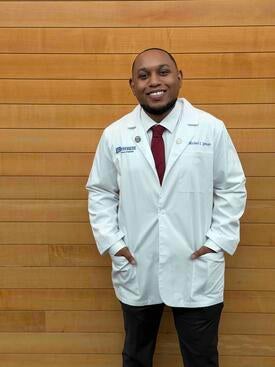 Michael Spencer wearing a white coat