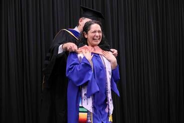Nina Ruedas walking at MPH commencement 2026