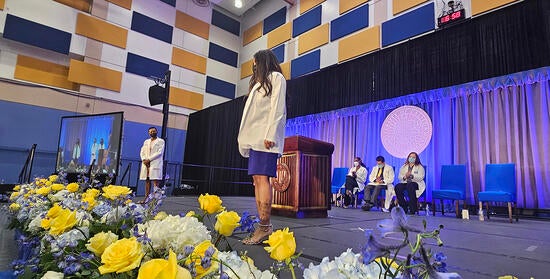 Class of 2027 White coat - student on stage